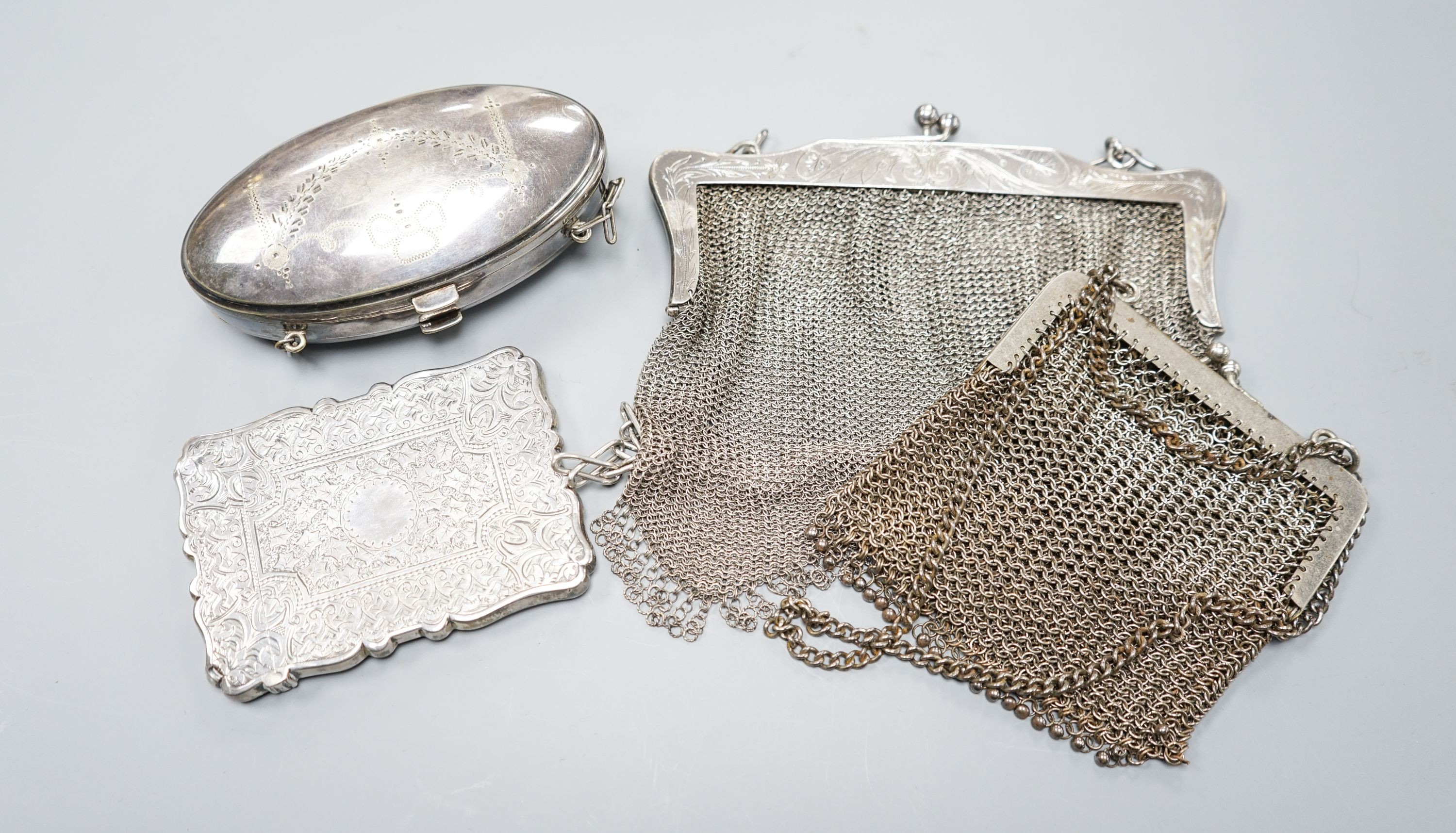 A late Victorian engraved silver card case, Birmingham, 1877, 10cm, a silver mesh evening purse and two other plated items.
